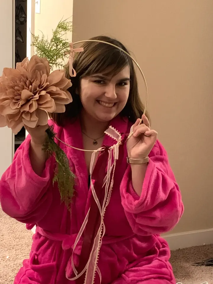Nikky smiling while wearing a handmade flower headpiece